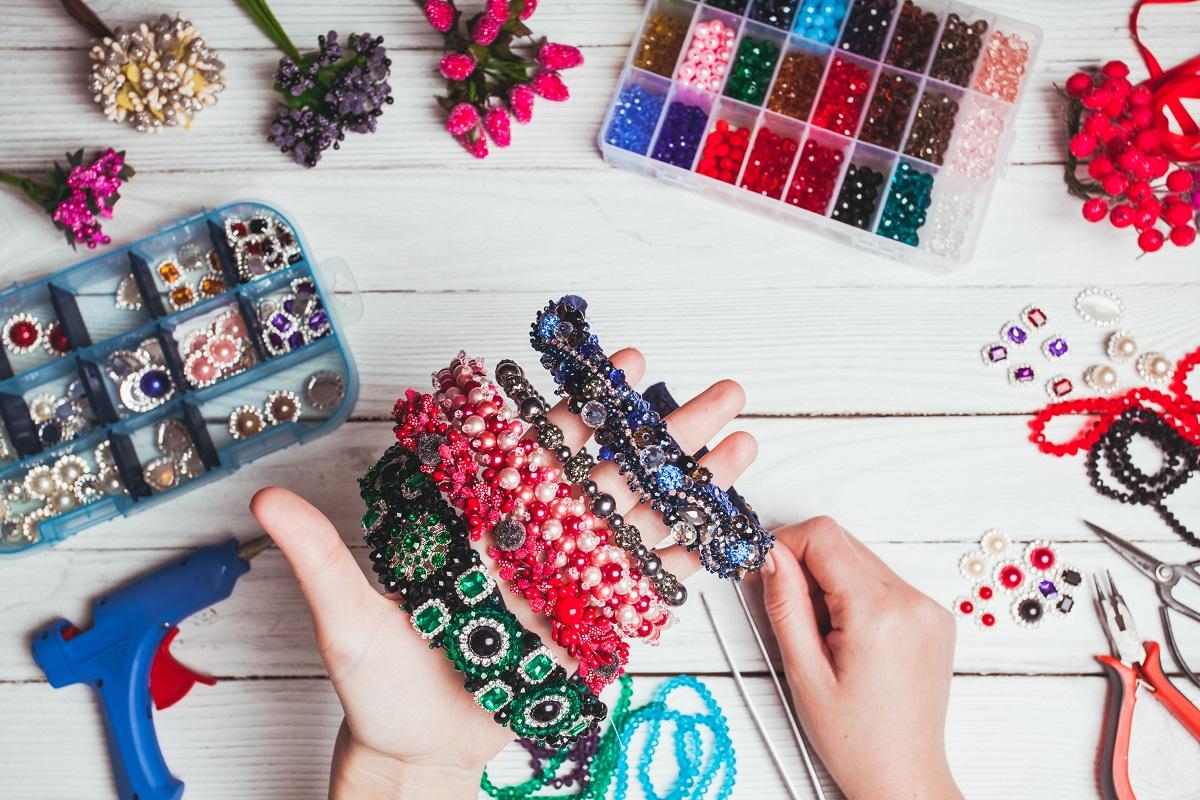 7 Best Glue for Jewelry | Reviews + Guide Plastic berries, flowers, beads and instruments for doing handmade headbands. Top view with hands