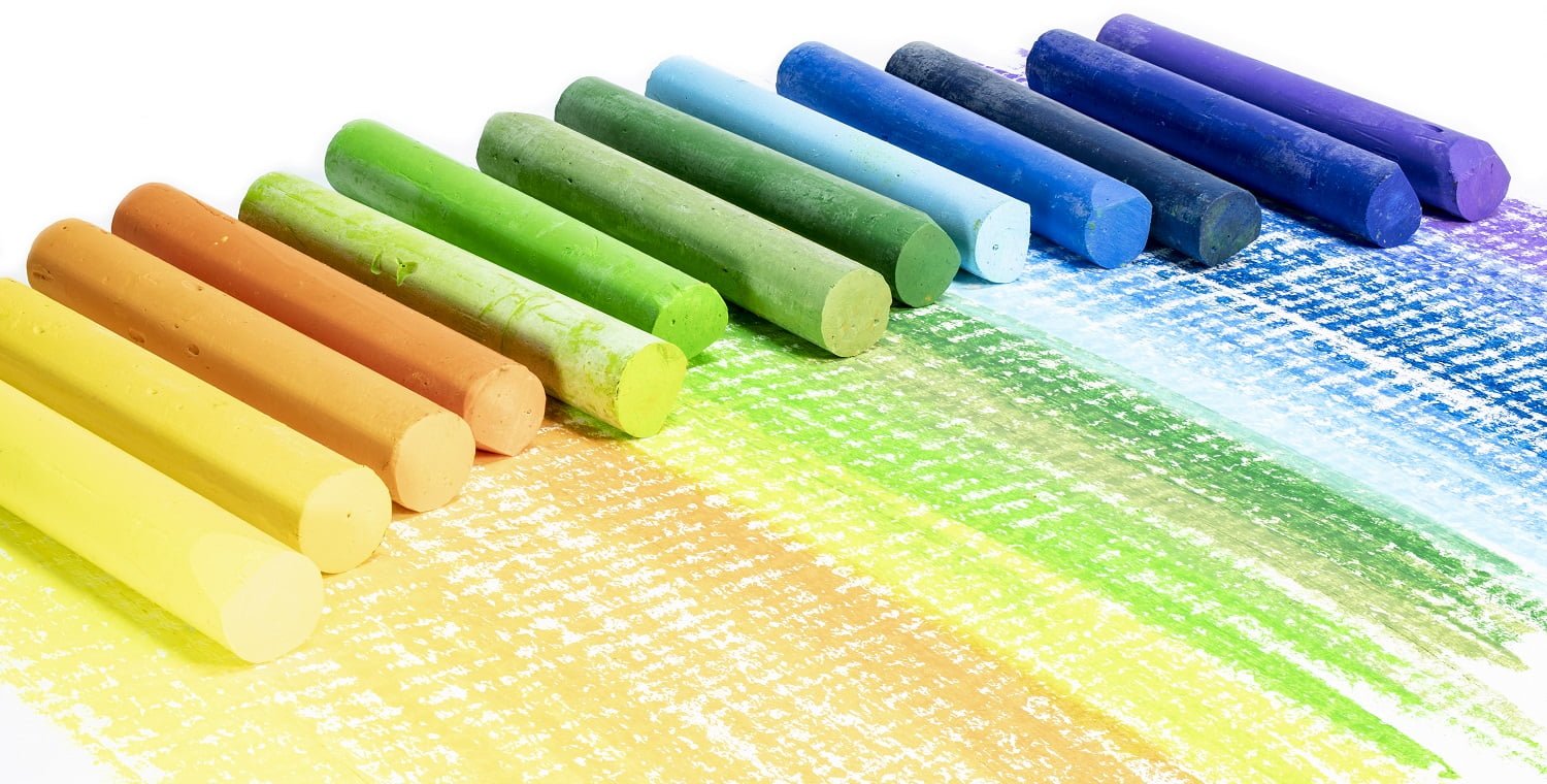 Multi-colored pastel crayons. Materials for drawing and creativity. Bright water-based paints. School supplies. Hobbies and creativity.